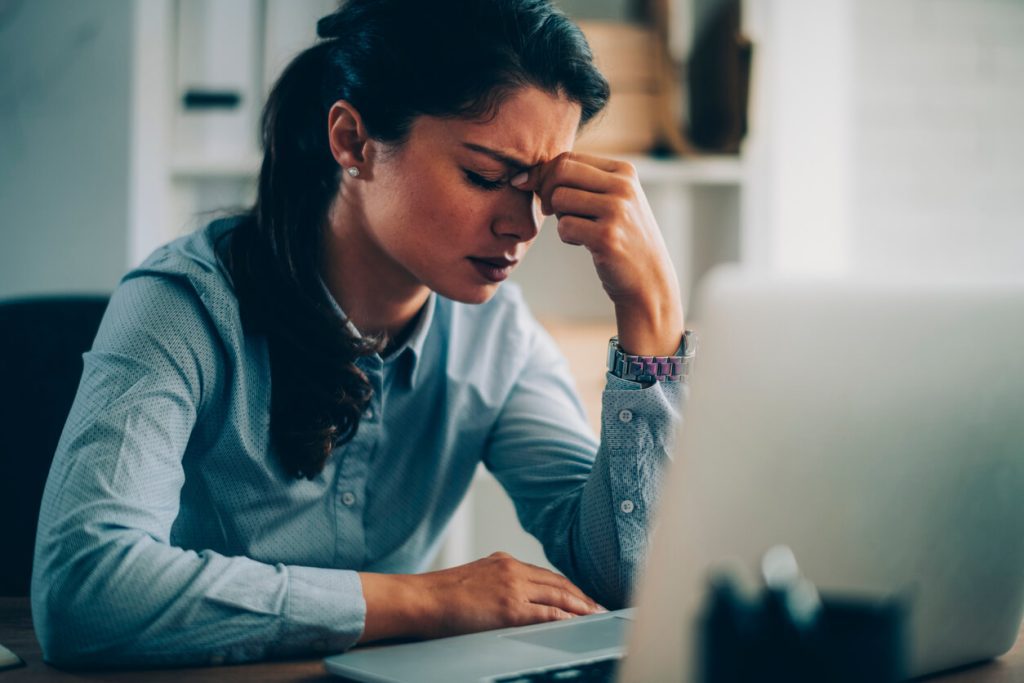 Mulher preocupada olhando para o computador.